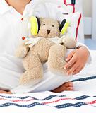 Close-up of a teddy bear with headphones on