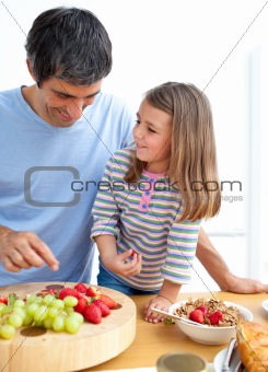 Happy father and his daughter having breakfast
