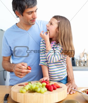 Cheerful father and his daughter having breakfast