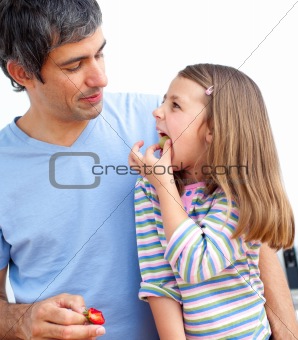 Smiling father and his daughter having breakfast