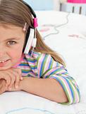 Little gril listening to music with headphones 