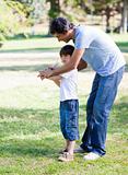 Loving little boy playing baseball with his father