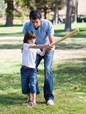 Positive father teaching baseball to his son