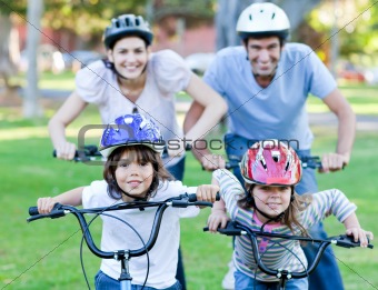 Happy family riding a bike 