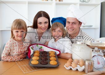 Cheerful family presenting their muffins