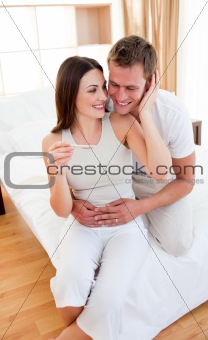Enamored couple finding out results of a pregnancy test 