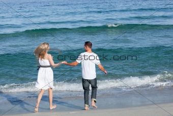 Loving couple walking at the seaside