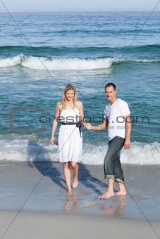Intimate couple walking at the seaside
