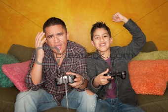 Hispanic Man and Boy Playing Video game