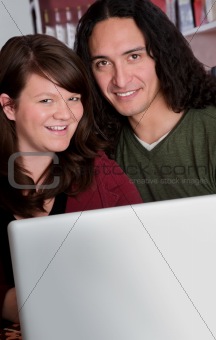 Interracial couple with copy space in front of laptop