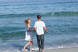 Beautiful couple walking together at the seaside