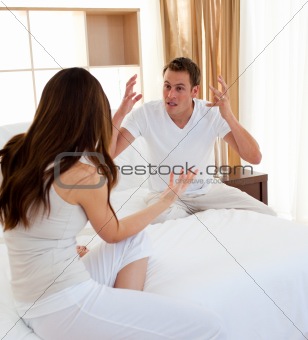 Resentful couple having an argument in the bedroom