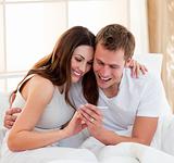 Joyful couple finding out results of a pregnancy test