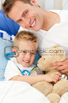 Handsome father and his sick son playing with a stethoscope