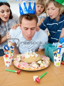 Joyful family celebrating father's birthday