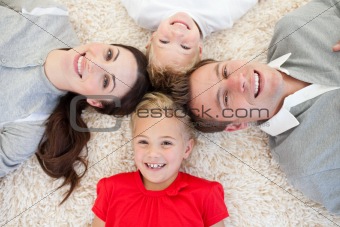 Happy family lying on the floor