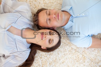 Affectionate couple lying on the floor
