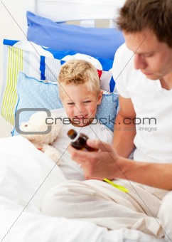 Caring man looking after his sick son