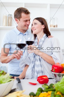 Affectionate couple drinking wine while cooking