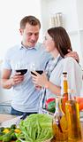 Romantic couple drinking wine while cooking 