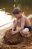 The boy builds on sand