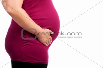 Young pregnant Caucasian woman holding her belly
