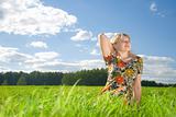 beautiful young woman on field of green grass 