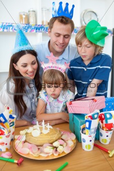 Merry little girl celebrating her birthday in the kitchen