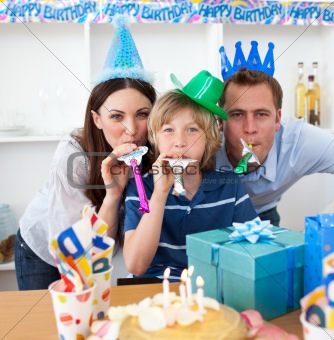Happy parents celebrating their son's birthday in the kitchen