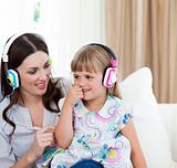 Portrait of a mother and her daughter listening music 