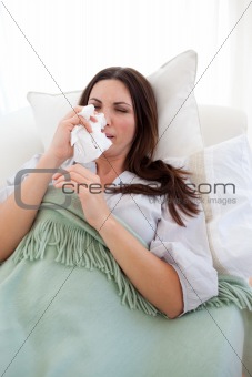 Woman with the flu lying on the sofa