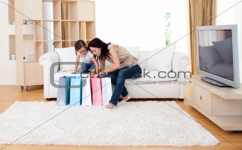 Jolly mother and her daughter at home after shopping