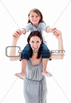 Pretty mother giving her daughter piggyback ride