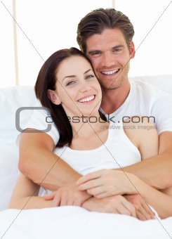 Jolly man hugging his wife 
