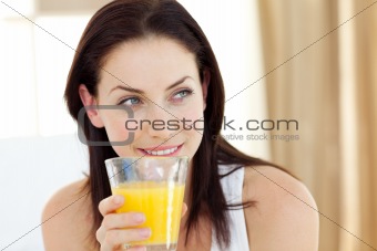 Attractive woman drinking orange juice 