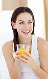 Laughing woman drinking orange juice
