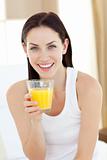 Smiling woman drinking orange juice 