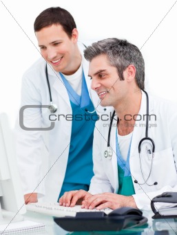 Two male doctors working at a computer