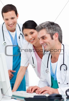 Positive medical team working at a computer