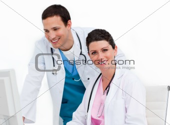 Two positive doctors working at a computer