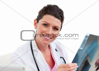 Young female doctor looking at X-ray