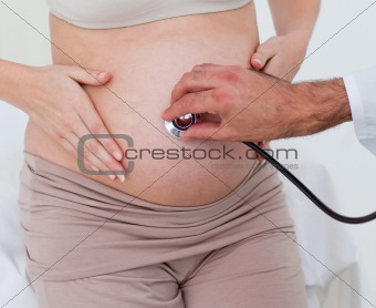 Close-up of a pregnant woman examined by her gynecologist