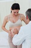 Caucasian pregnant woman examined by her gynecologist