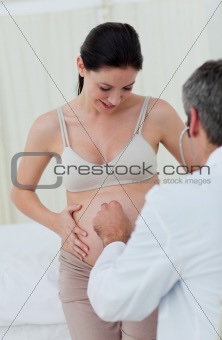 Caucasian pregnant woman examined by her gynecologist