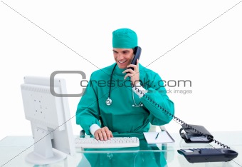 Positive surgeon on phone working at a computer