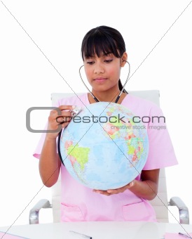 Portrait of an ethnic doctor examining a terrestrial globe