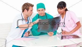 Successful medical team looking at X-ray