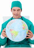 Charming doctor holding terrestrial globe