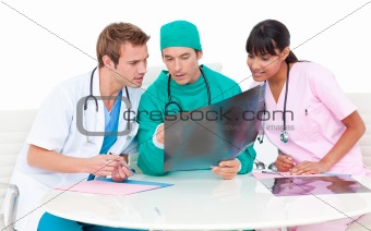 Concentrated medical team looking at X-ray