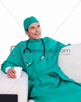 Relaxed surgeon drinking coffee in the staff room